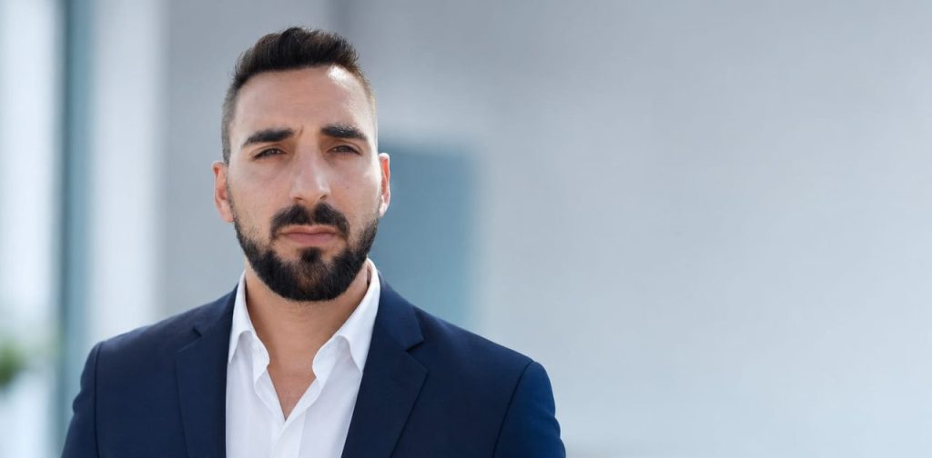 Álvaro García, founder of ANABAINO, in a professional portrait wearing a navy suit against a blurred office background.